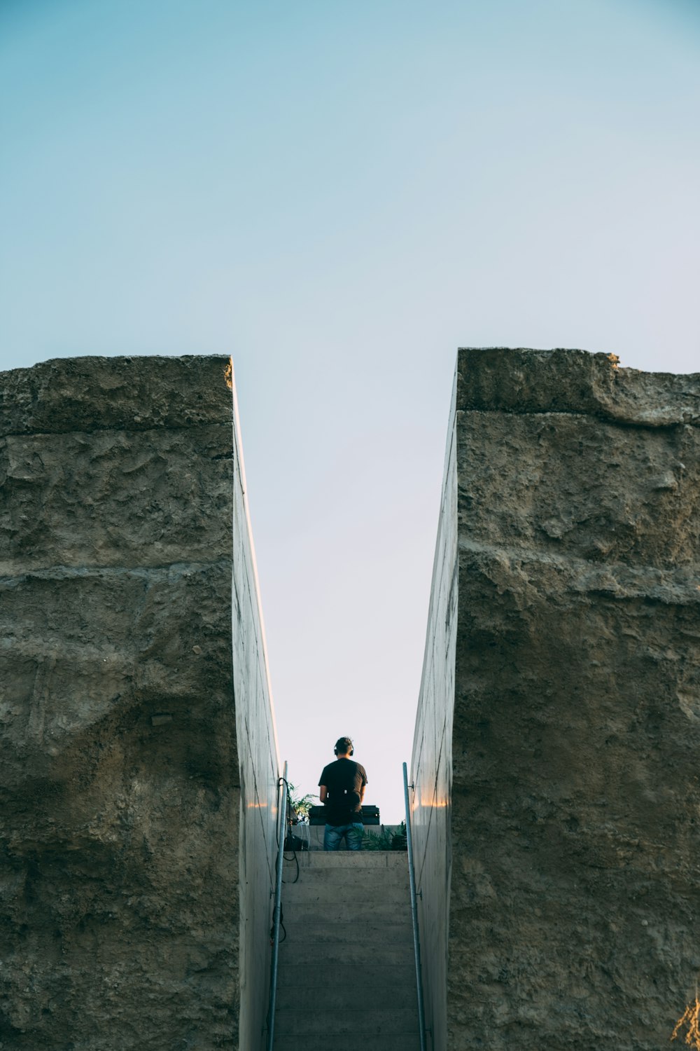 people climbing on gray concrete wall during daytime