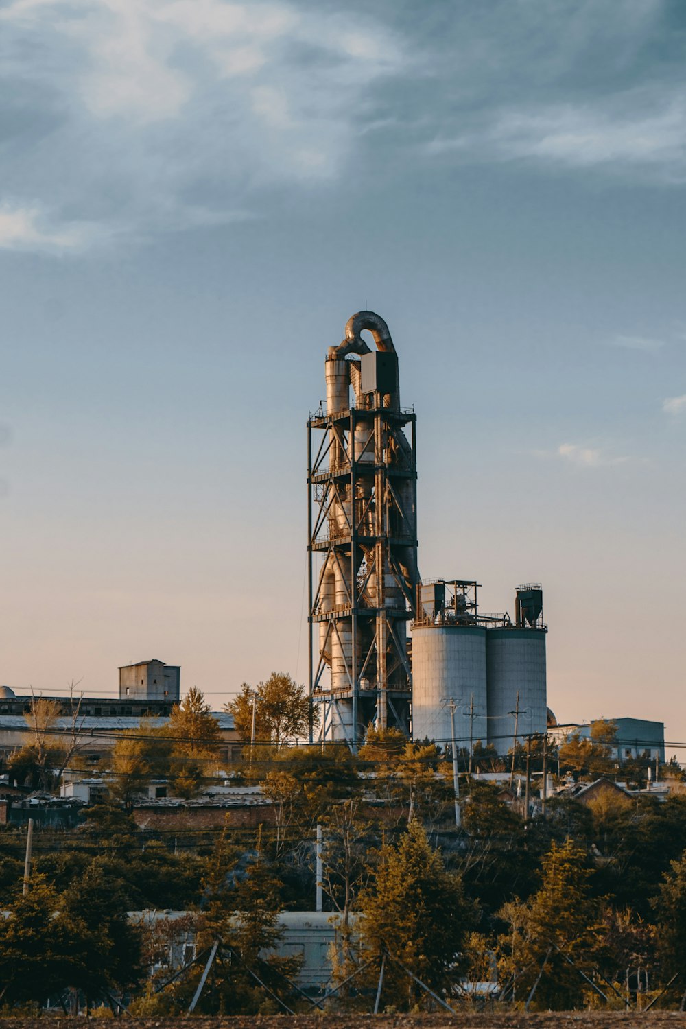 brown and gray factory under blue sky during daytime