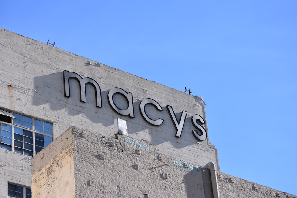 low angle photo of gray concrete building under blue sky during daytime