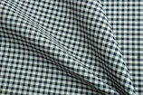 Close-up of a classic checkered shirt fabric draped over a mannequin.