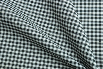 Close-up of a classic checkered shirt fabric draped over a mannequin.