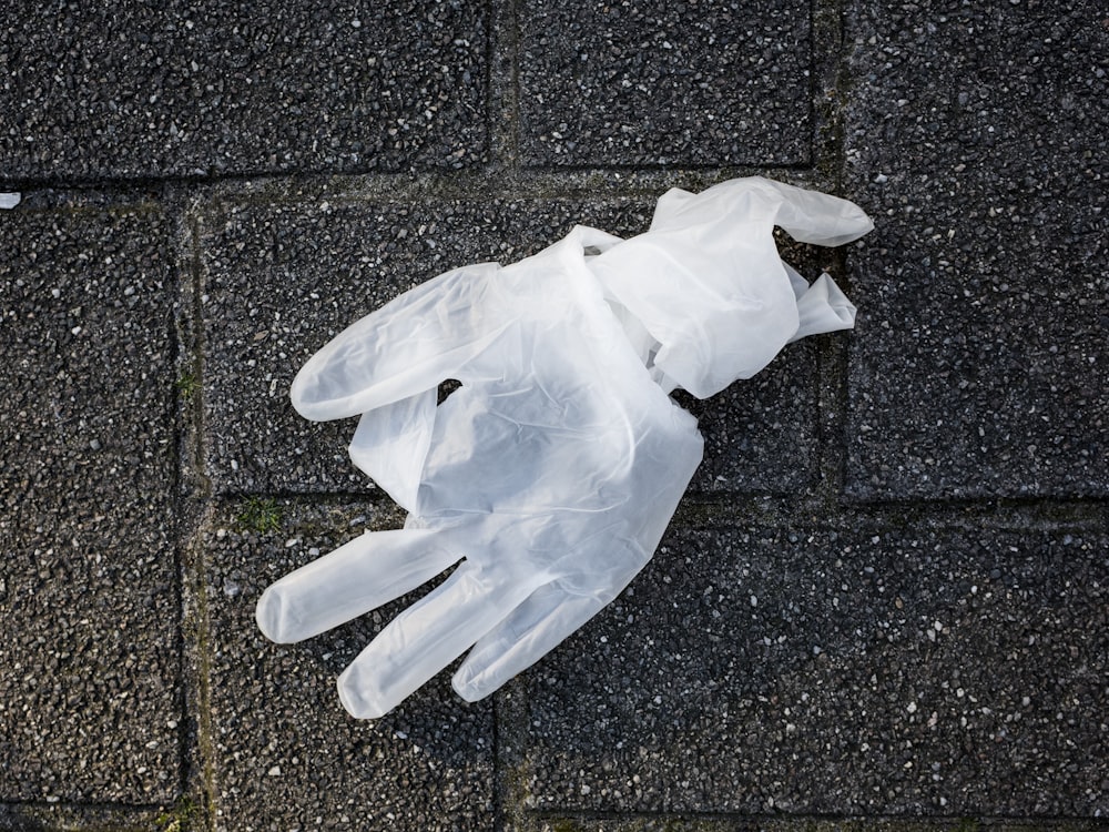 white plastic bag on gray concrete floor