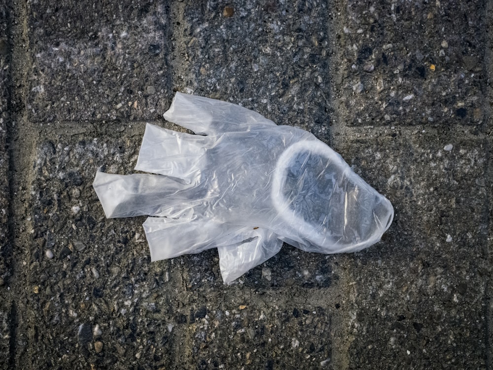 white plastic bag on gray concrete floor