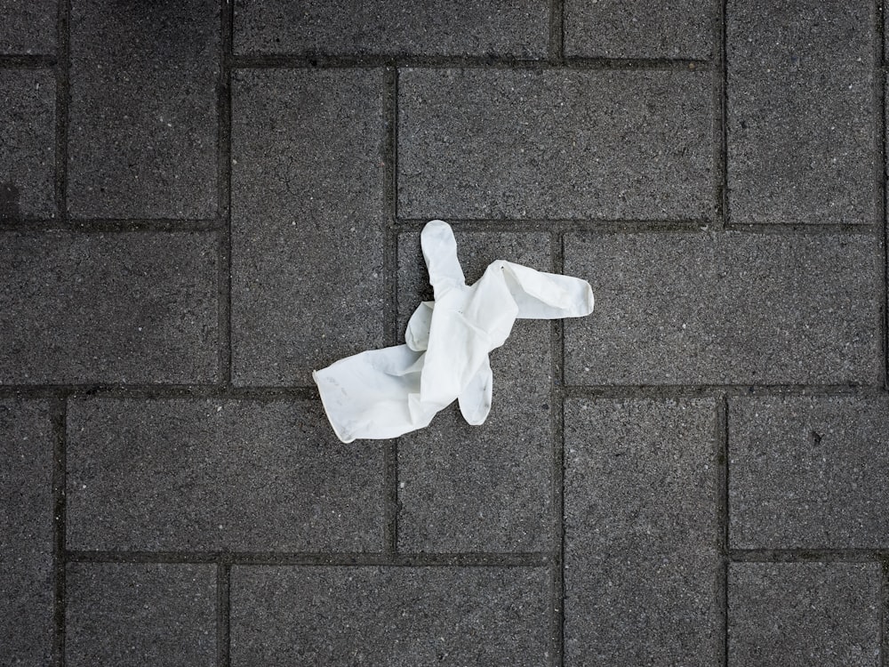 white paper on brown brick floor