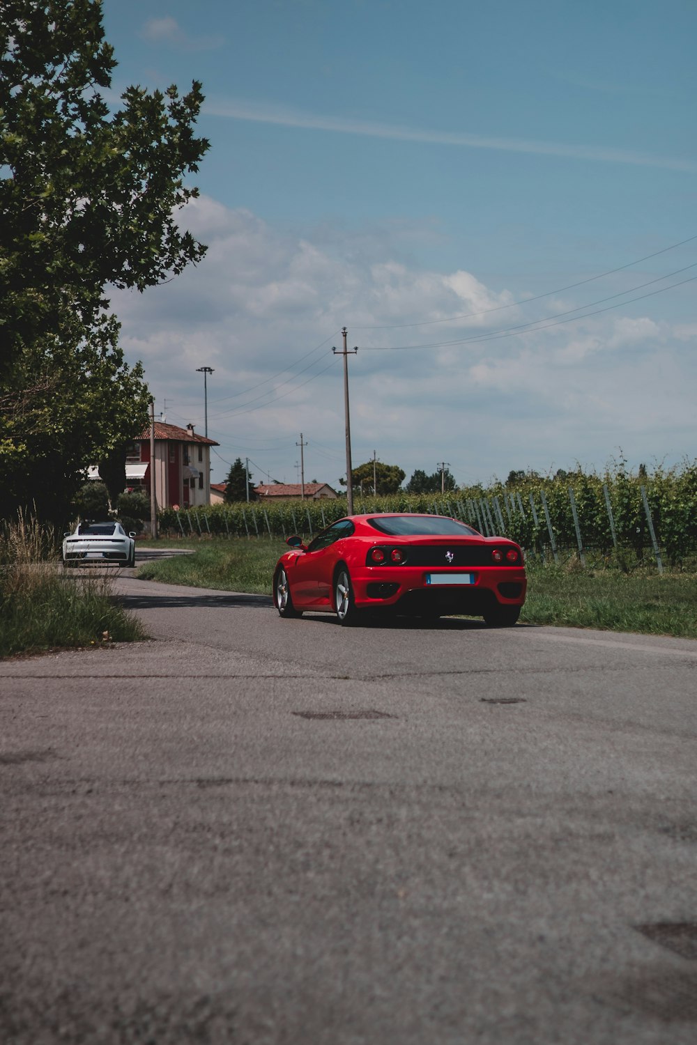 red ferrari coupe on road during daytime