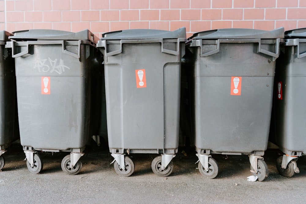 black garbage bins on sidewalk