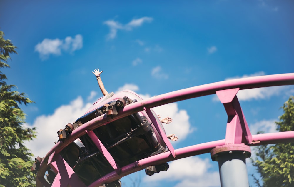 red and black helicopter flying under blue sky during daytime