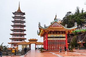 people walking on red and brown temple during daytime