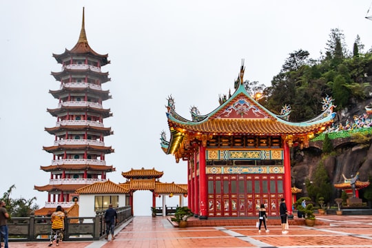 people walking on red and brown temple during daytime in Chin Swee Caves Temple Malaysia