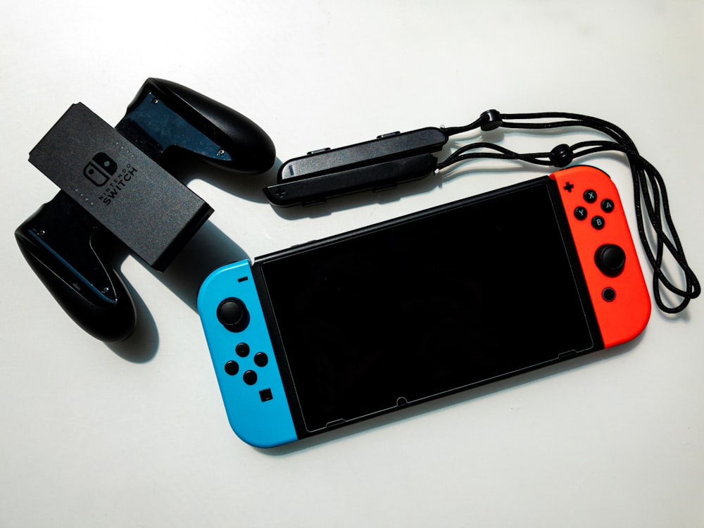 white nintendo switch beside black usb flash drive