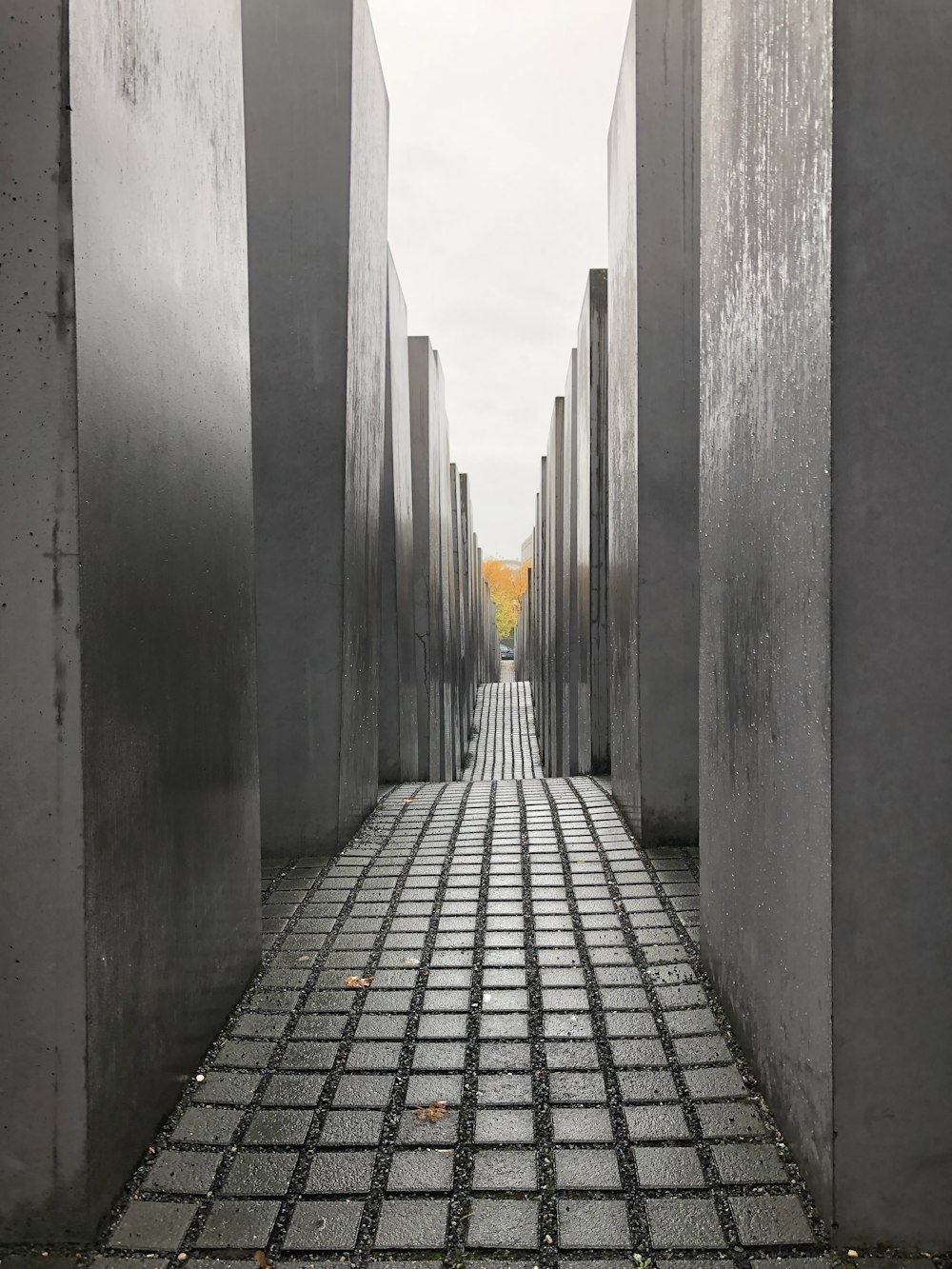 a walkway between two concrete pillars with a sky background