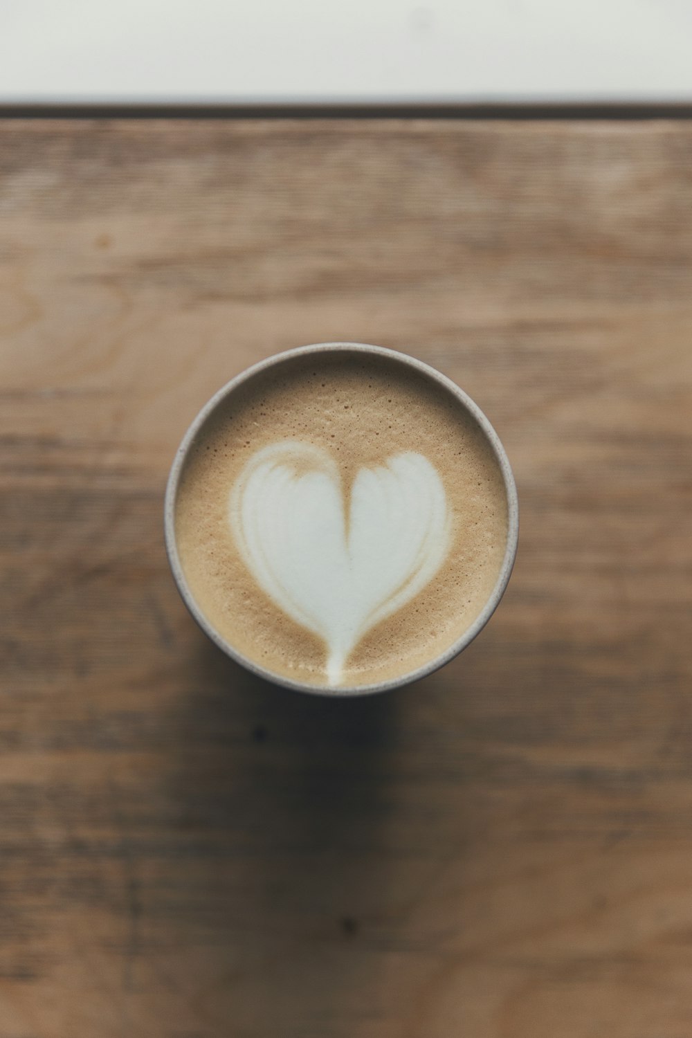 Kaffeekunst in Form von braunem und weißem Herz