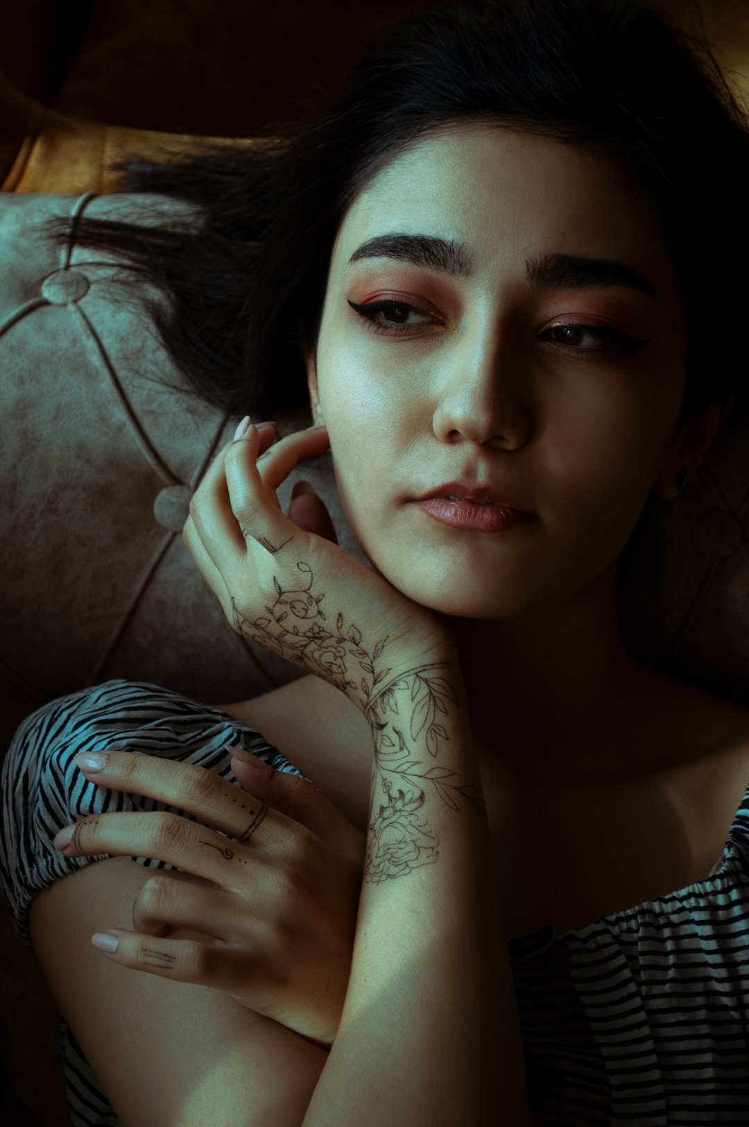 woman in black and white tank top with tattoo on her left hand