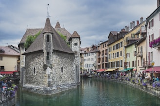 people walking on river between buildings during daytime