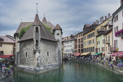 people walking on river between buildings during daytime