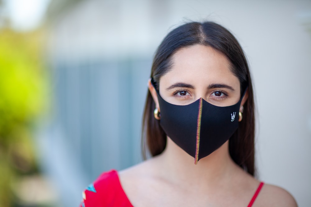 woman in red shirt with black mask