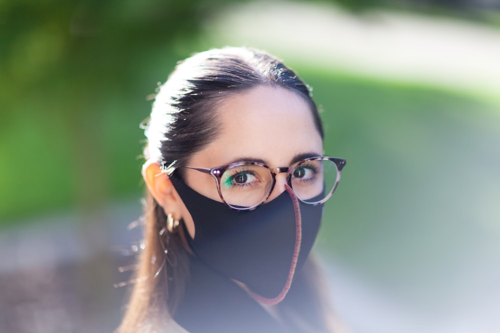 woman in white shirt wearing black framed eyeglasses