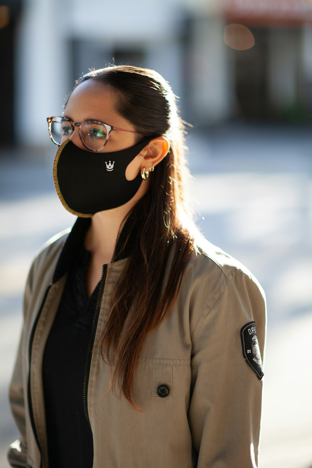woman in brown coat wearing black sunglasses