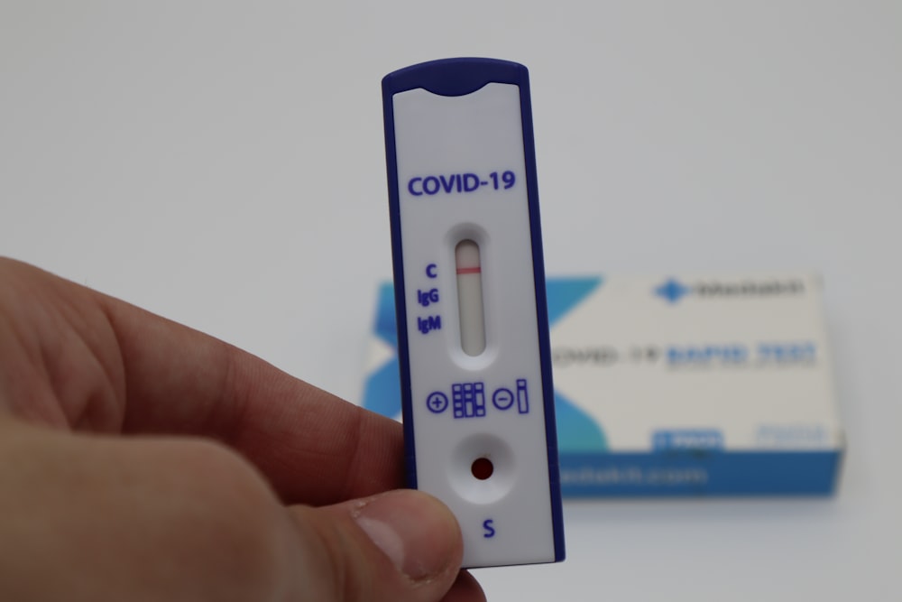 white and blue pregnancy test kit