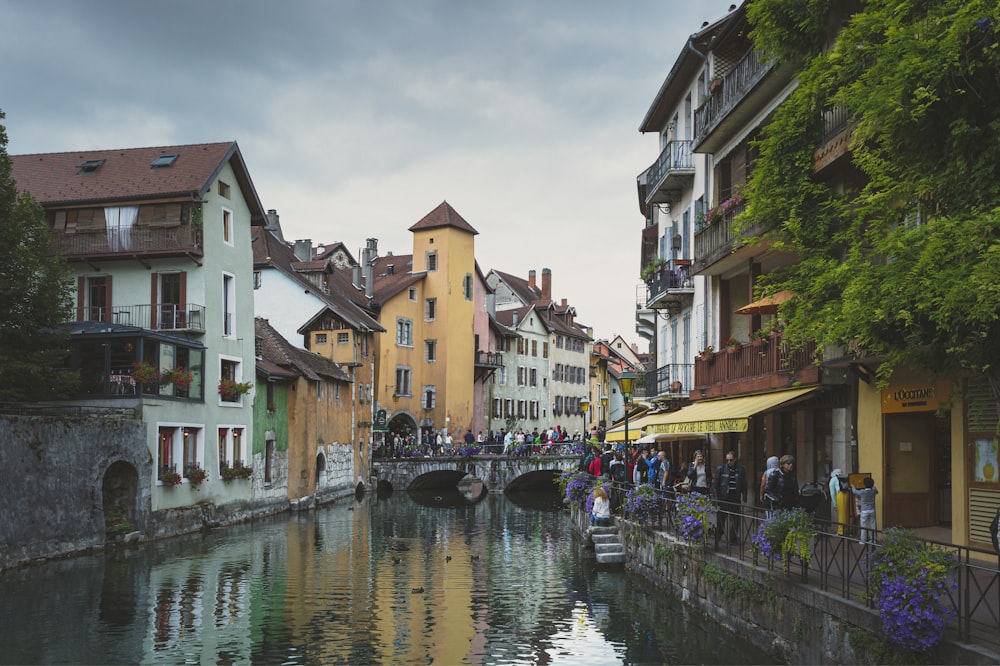 boat on river between buildings during daytime