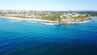 aerial view of city beside sea during daytime