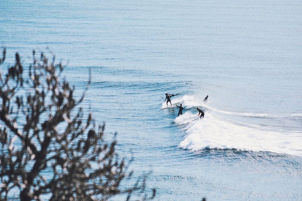 person surfing on sea waves during daytime