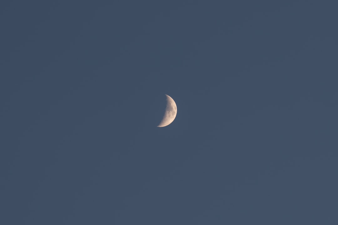 full moon in the sky, Crescent moon with a gold glow on a lighter blue sky