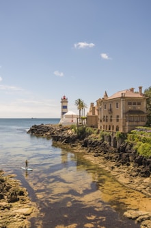 brown concrete building near body of water during daytime