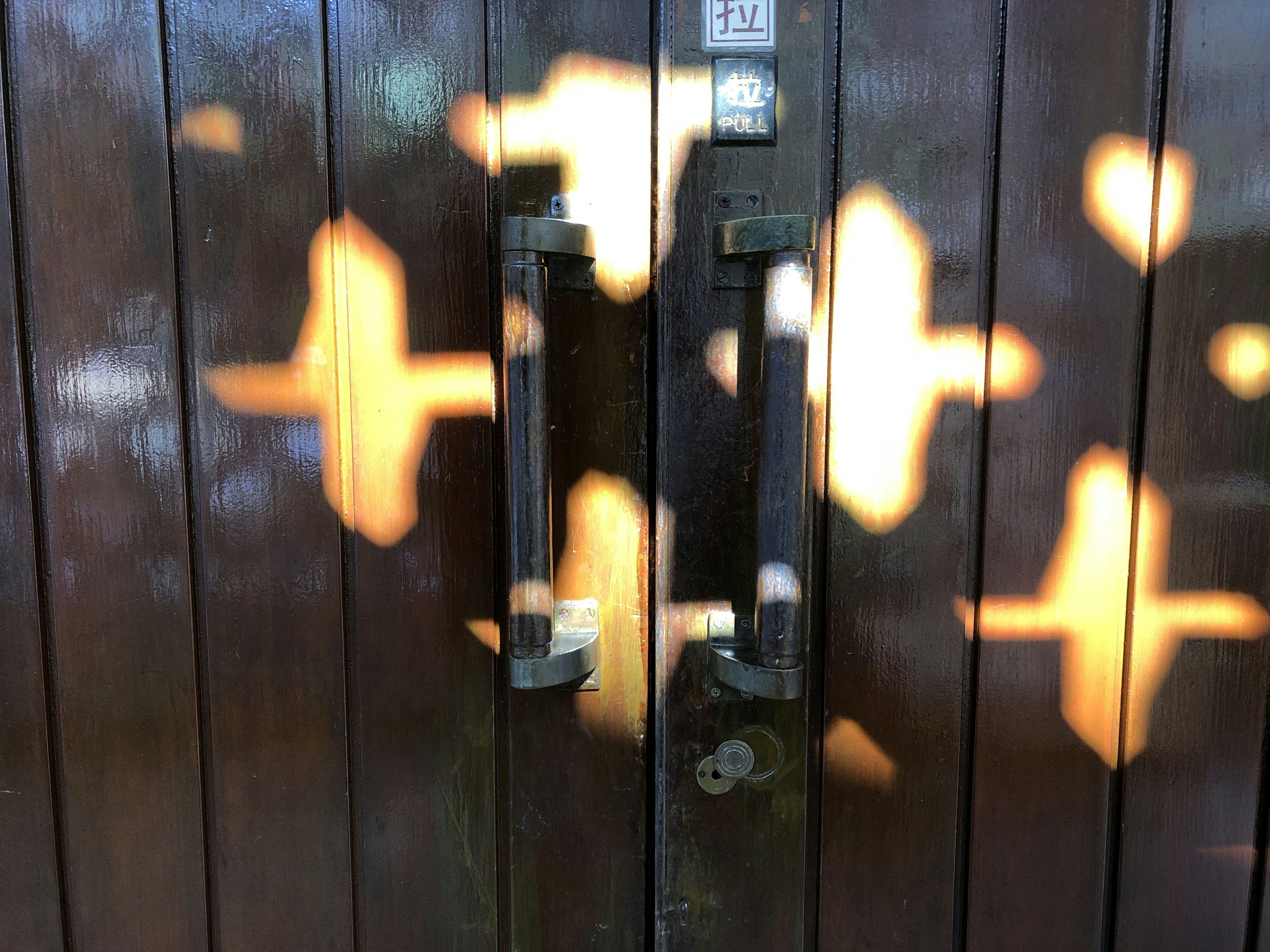 black wooden door with gold door lever