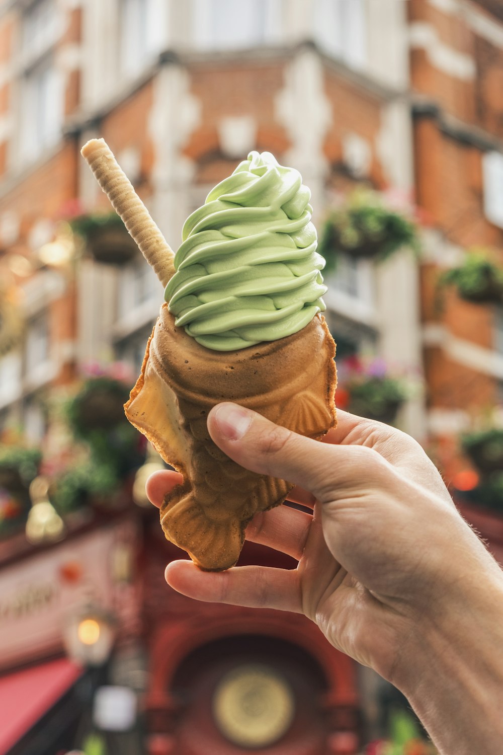 person holding brown ice cream cone