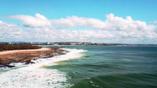 body of water near bridge under blue sky during daytime in Sunshine Coast QLD Australia