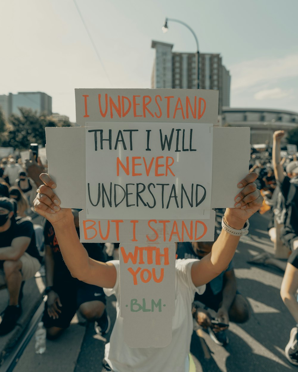 people holding white and black signage during daytime