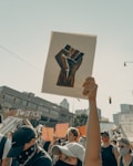 person holding brown wooden frame