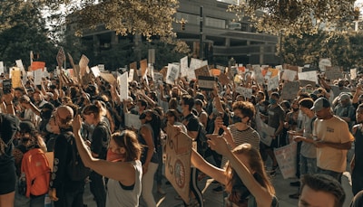 A vibrant protest scene showcasing diverse participants holding banners for cannabis legalization.
