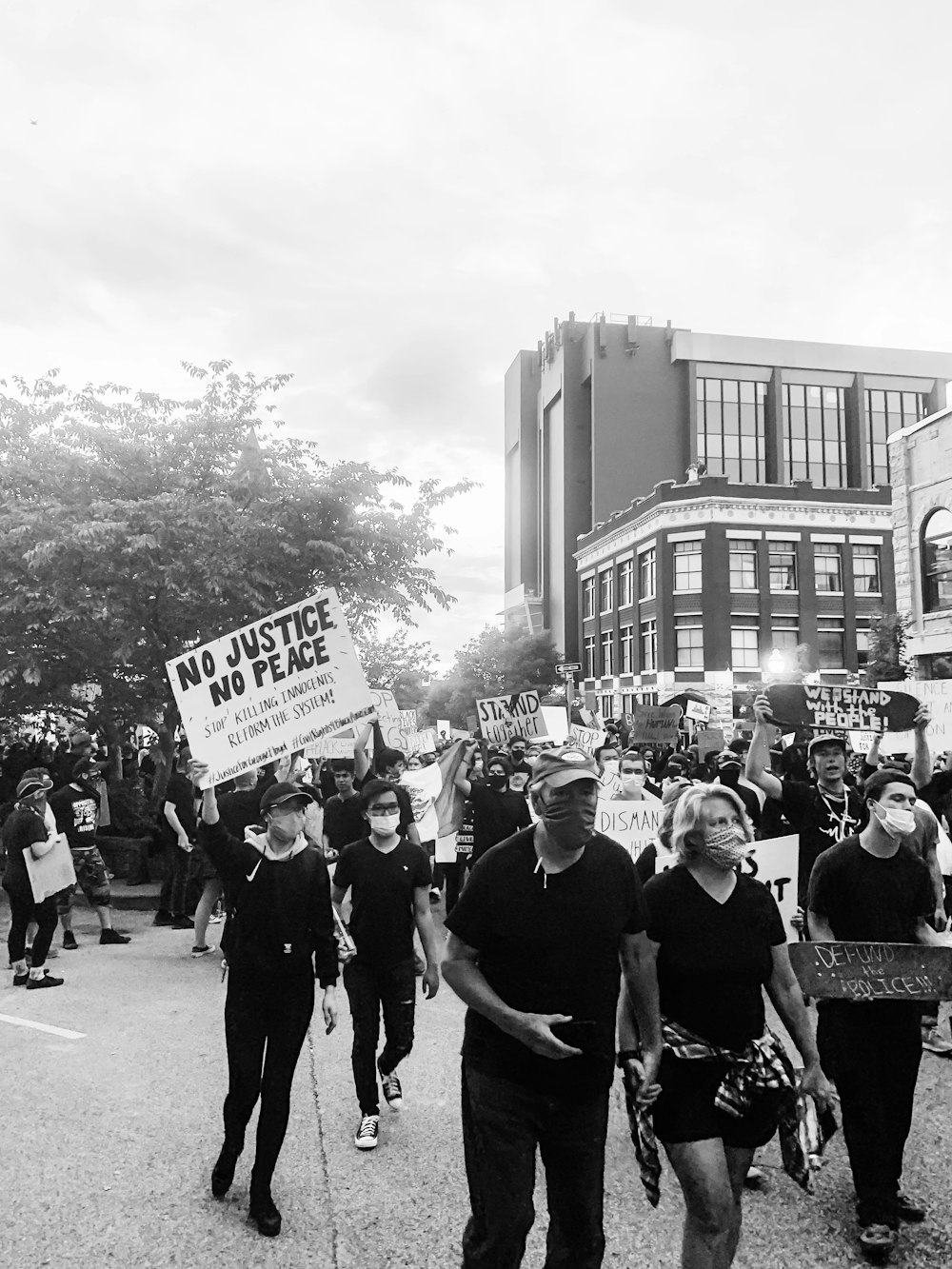 grayscale photo of people walking on street