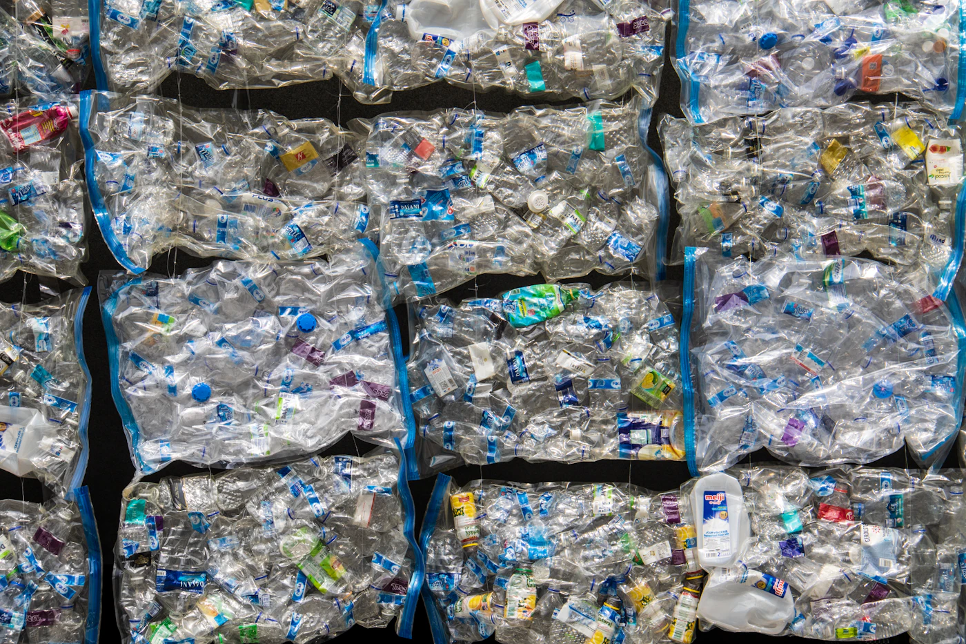 Blue and white plastic packaging arranged in rows