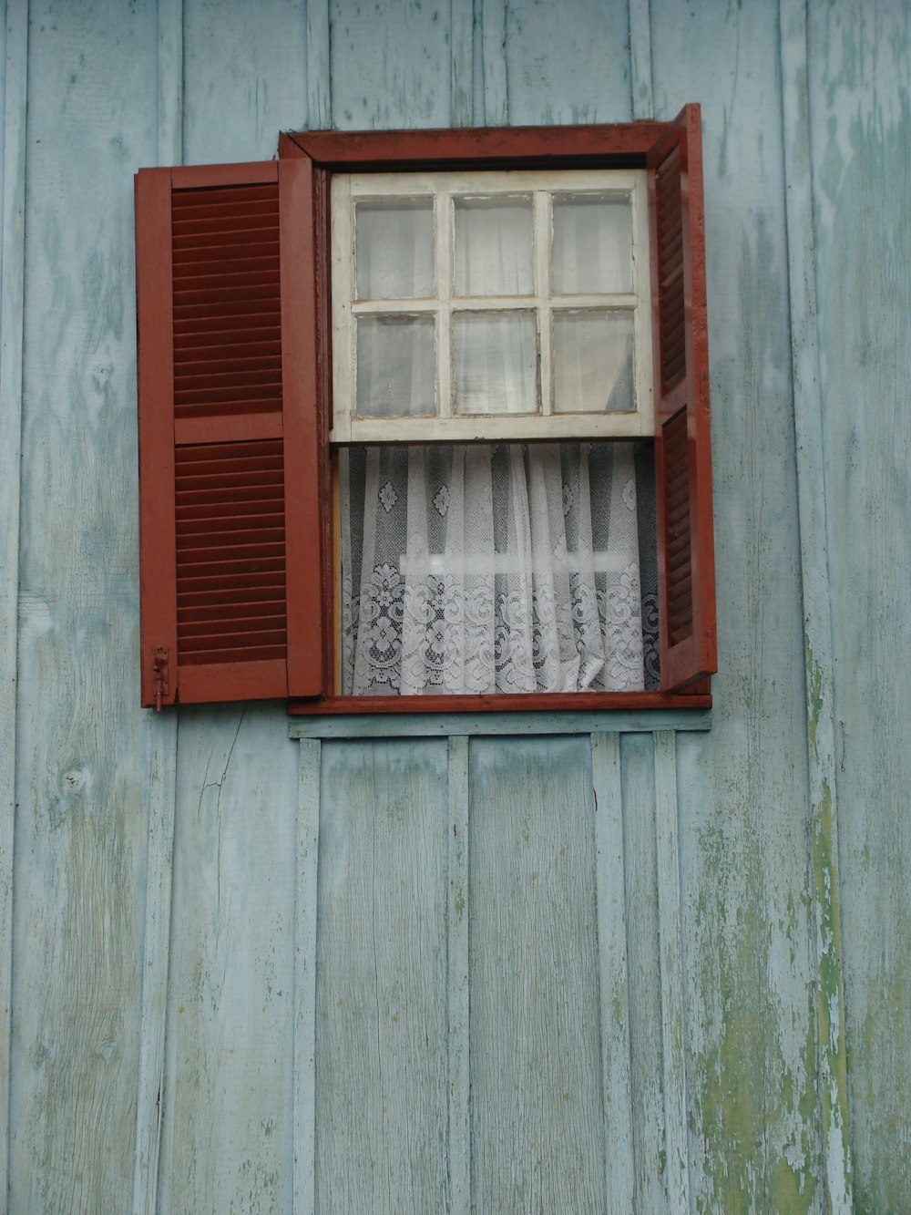 red wooden framed glass window