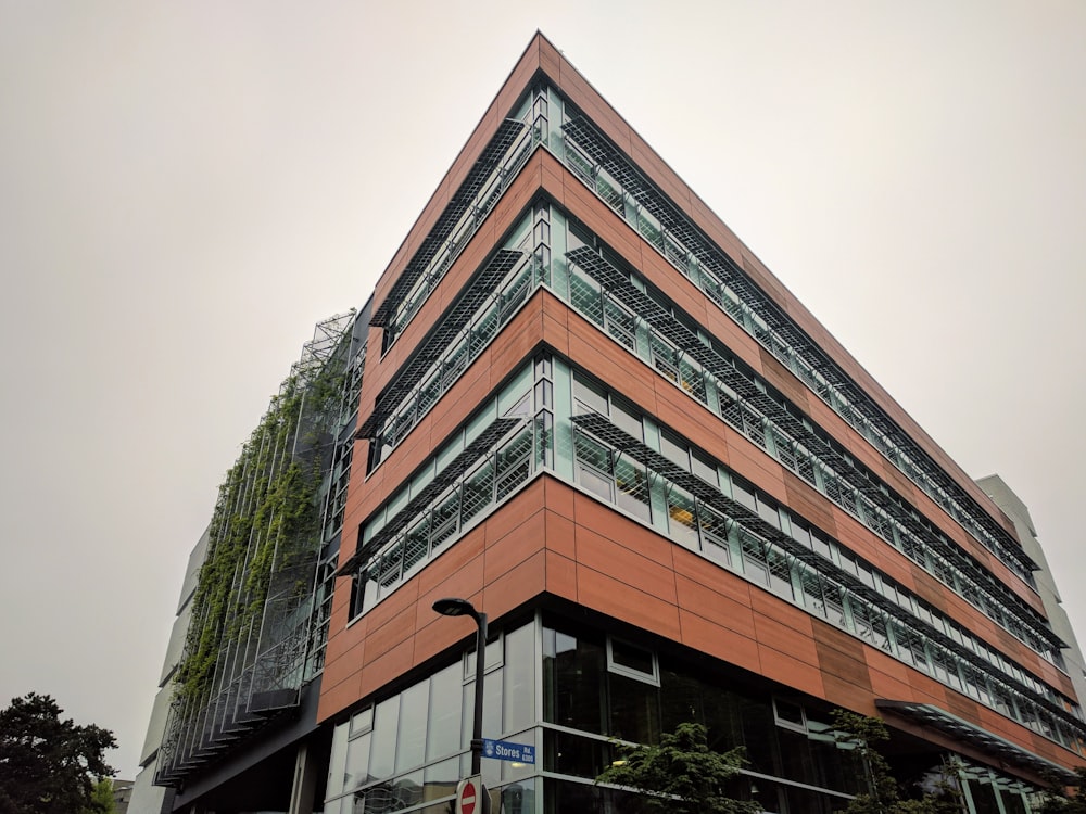 brown concrete building near green mountain during daytime