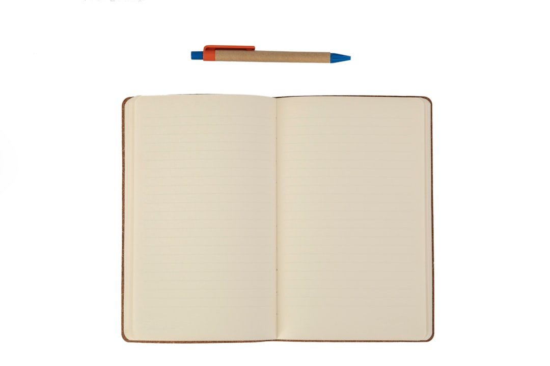 an empty notebook and pencil on the white background