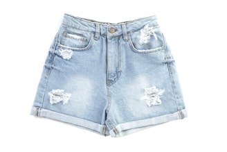 blue denim shorts on white surface