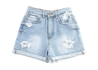 blue denim shorts on white surface