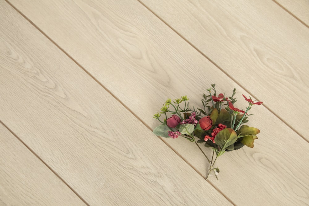 red roses on white wooden surface
