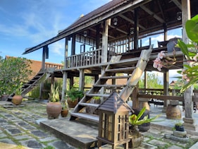 brown wooden stairs near brown wooden house during daytime