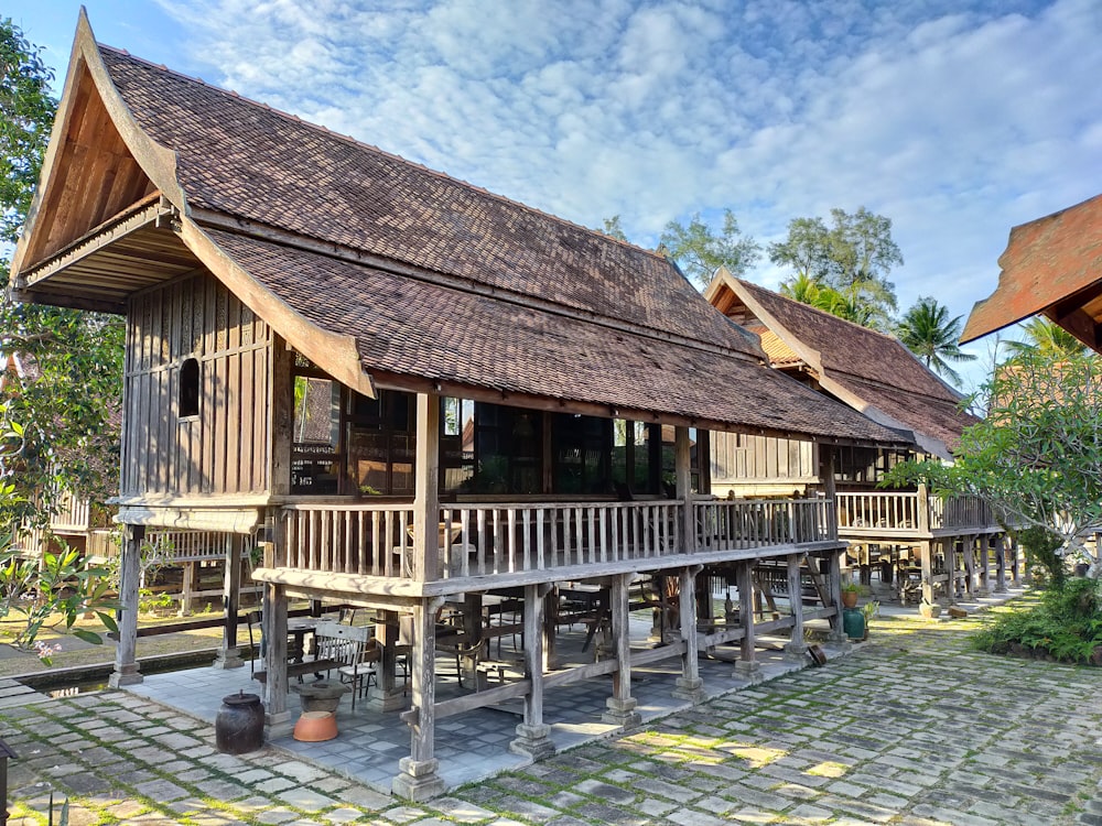 brown wooden house near body of water during daytime