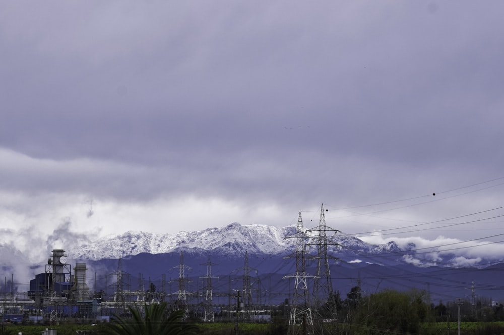 snow covered mountains under white cloudy sky during daytime