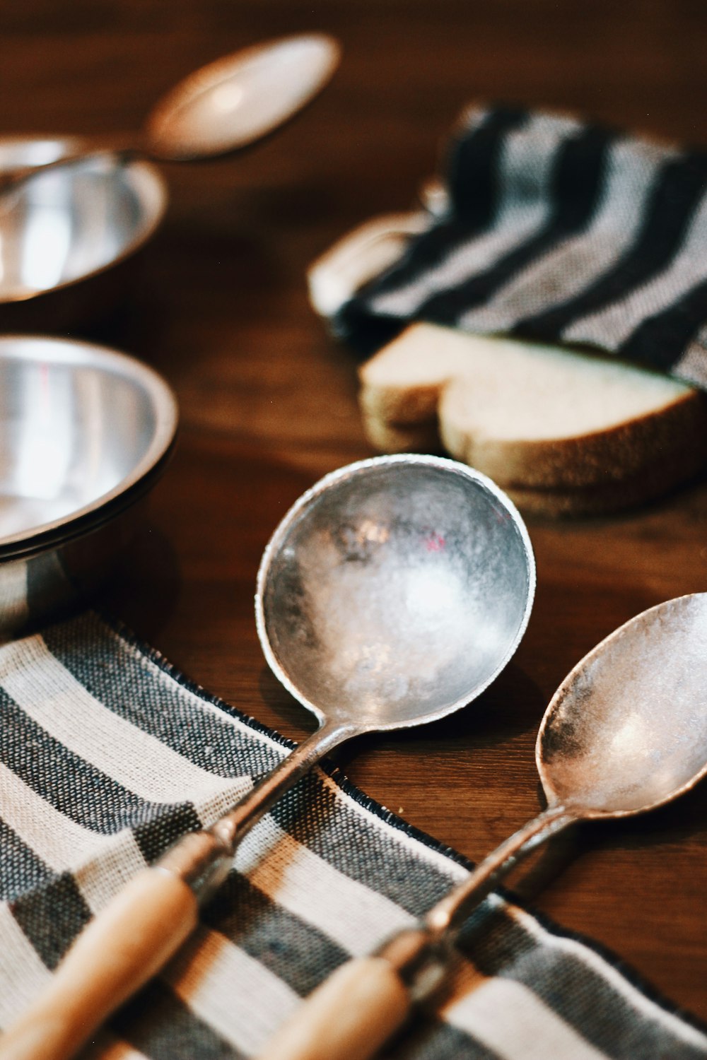 stainless steel spoon on brown wooden table