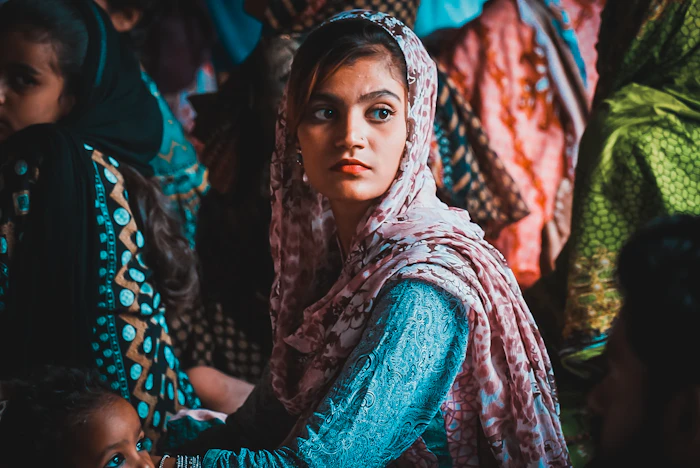 Illustrative stock portrait — Pakistani woman in green and brown hijab