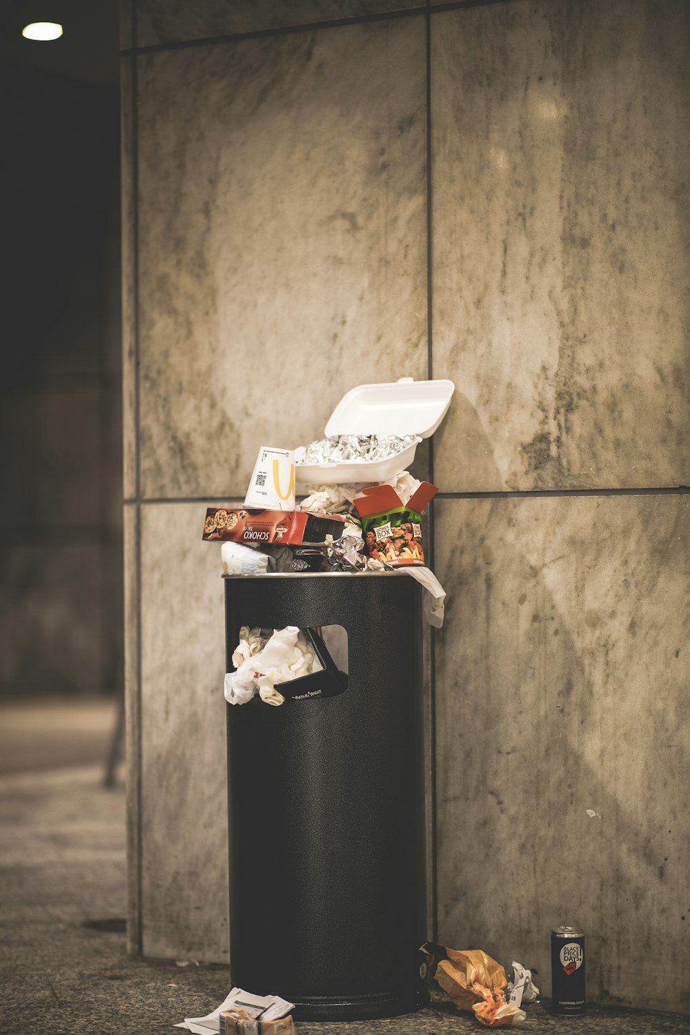 black and white plastic trash bin