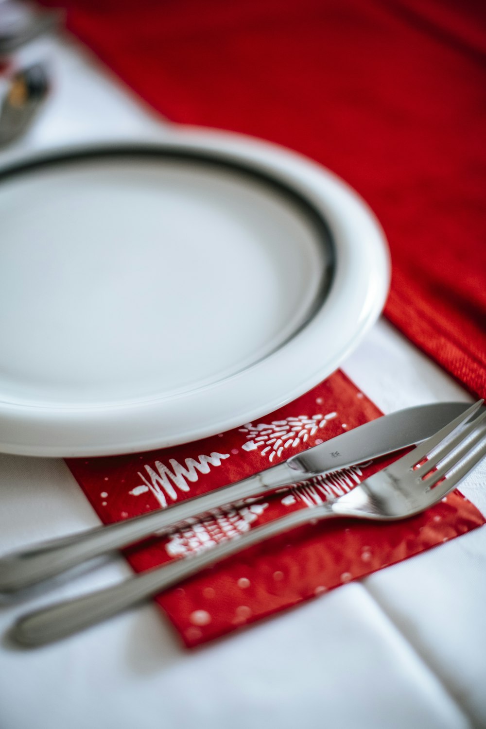 stainless steel fork beside white ceramic plate