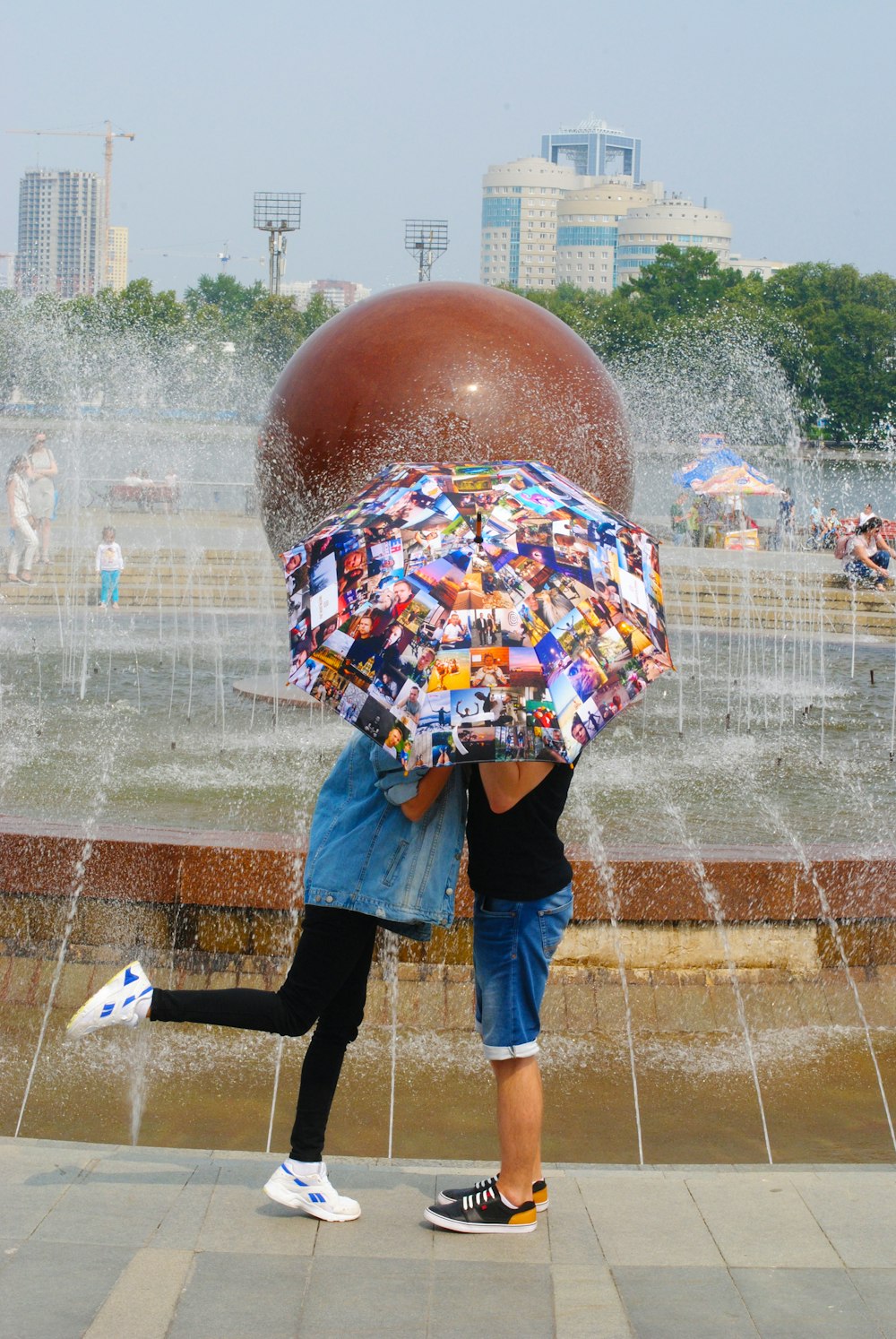 woman in blue denim jacket standing near water fountain